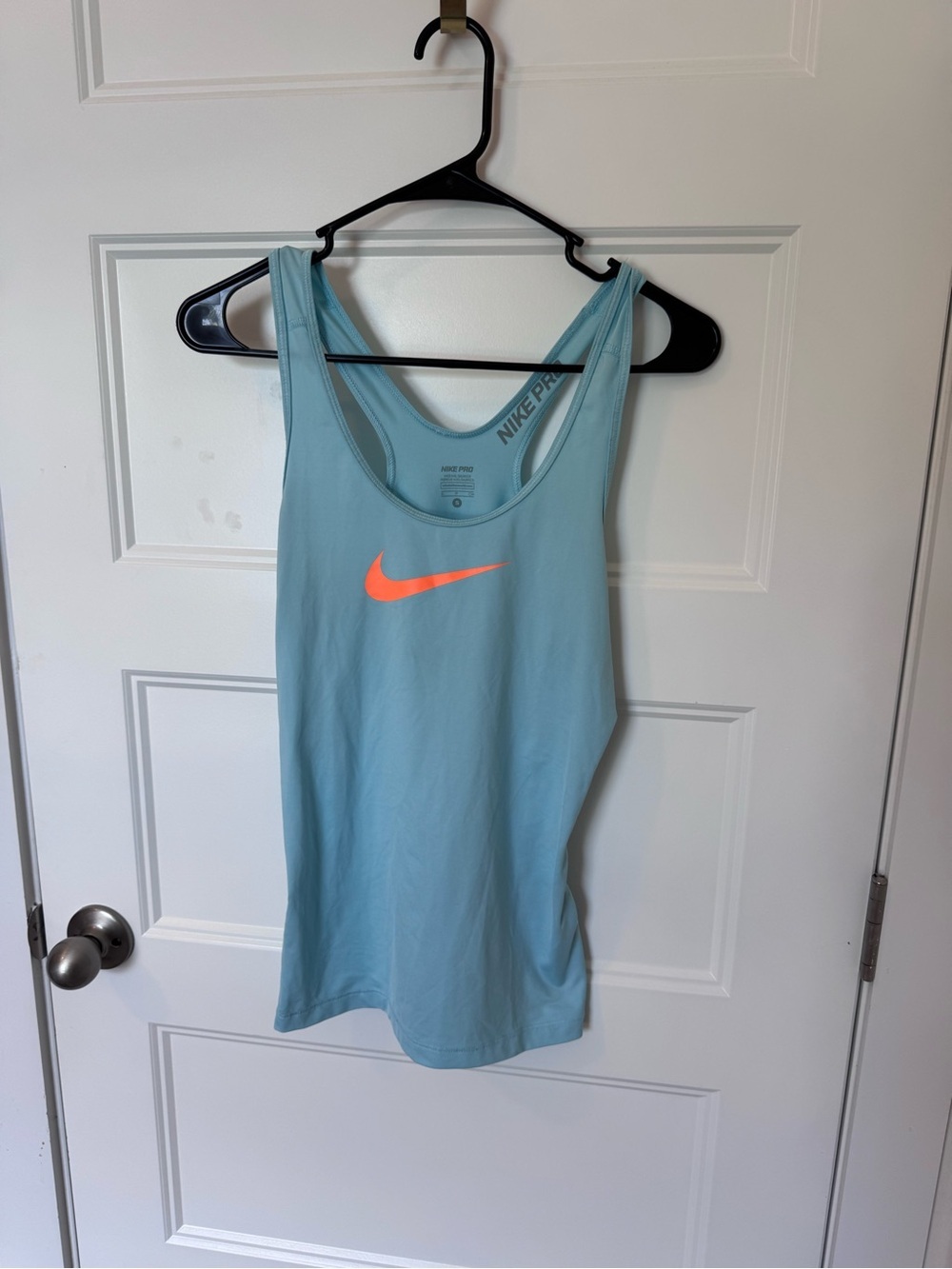 Nike Women's Light Blue Tank Top with Neon Orange Swoosh
